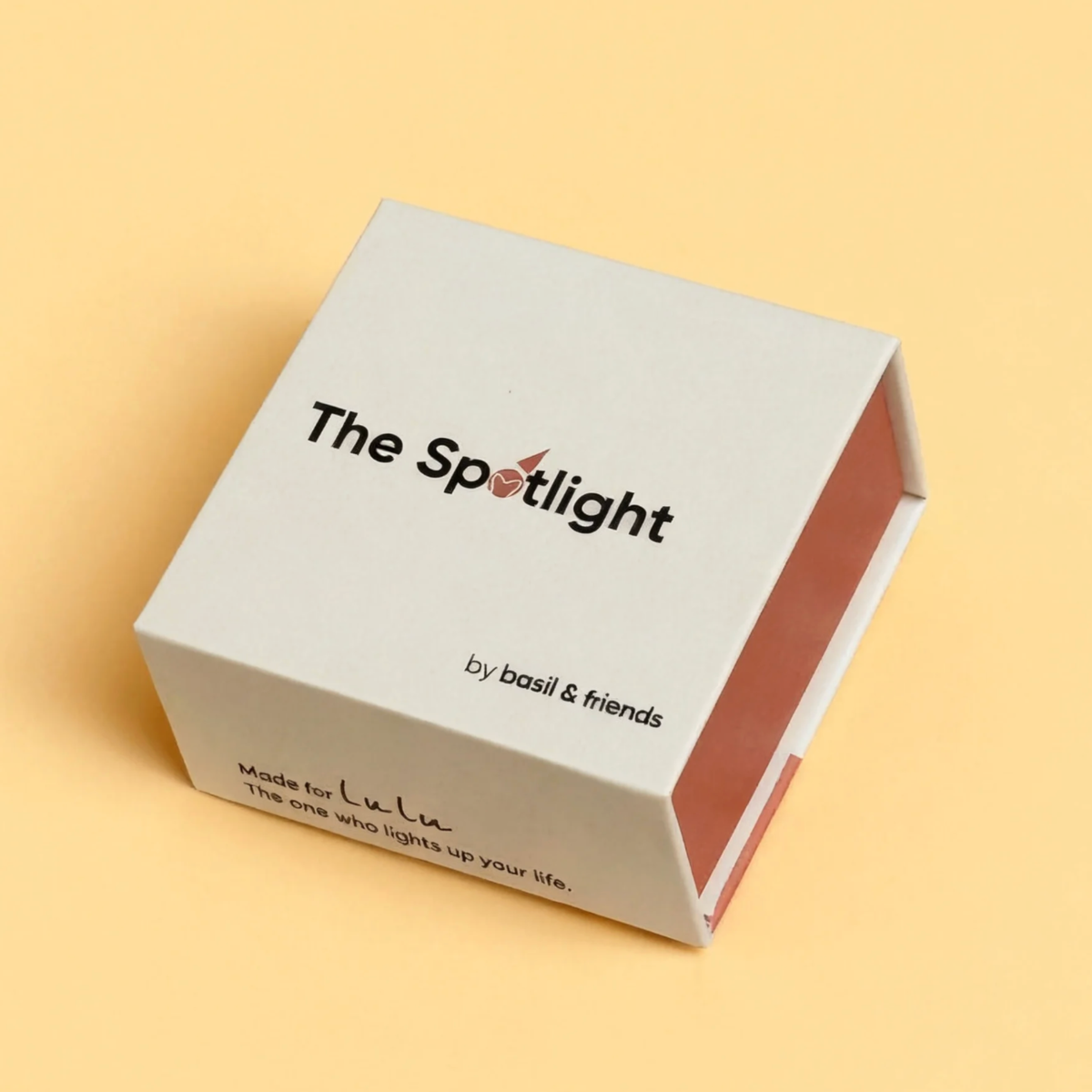 The elegant white and terracotta packaging box for The Spotlight by basil and friends. The side of the box features a personalized handwritten-style note reading, "Made for Lulu. The one who lights up your life," highlighting the custom gifting experience.